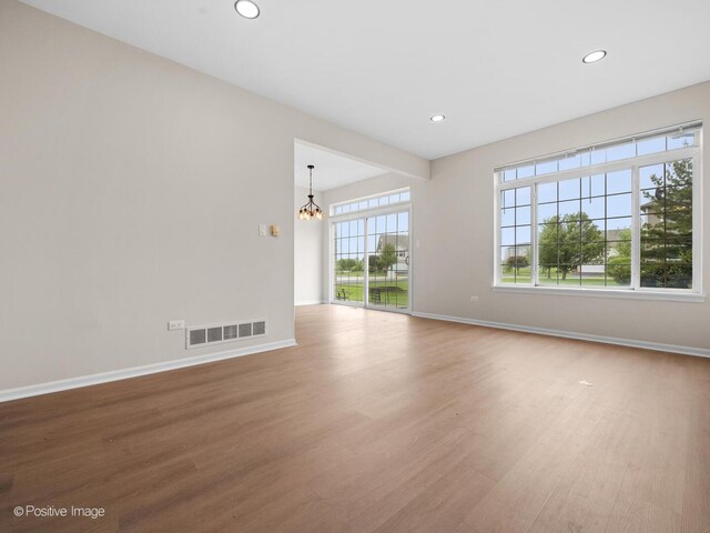 18506 Bellagio Cir, Tinley Park, IL 60477 - unfurnished living room featuring a chandelier, wood finished floors, and recessed lighting