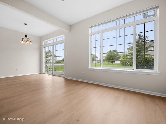 18506 Bellagio Cir, Tinley Park, IL 60477 - empty room with wood finished floors, a chandelier, and beam ceiling