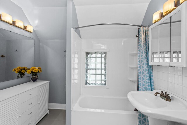 4039 N Kildare Ave, Chicago, IL 60641 - bathroom featuring vaulted ceiling, shower / bathtub combination with curtain, and tile patterned flooring