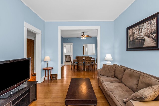 4039 N Kildare Ave, Chicago, IL 60641 - living area featuring wood finished floors, ceiling fan, and crown molding