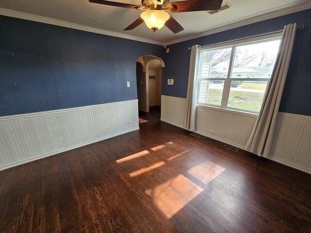 16517 Plainview Dr, Markham, IL 60428 - spare room featuring arched walkways, wainscoting, wood finished floors, ceiling fan, and ornamental molding
