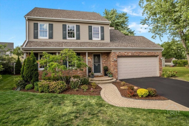 957 Whittington Dr, Geneva, IL 60134 - traditional home with an attached garage, asphalt driveway, a front yard, and brick siding