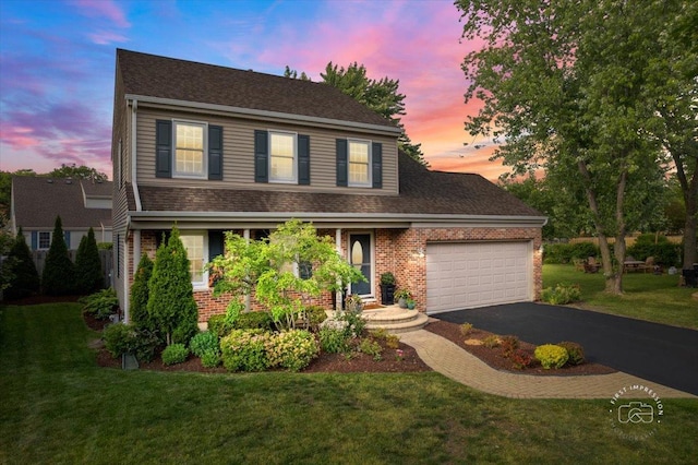 957 Whittington Dr, Geneva, IL 60134 - traditional-style home with a garage, asphalt driveway, a front yard, brick siding, and roof with shingles