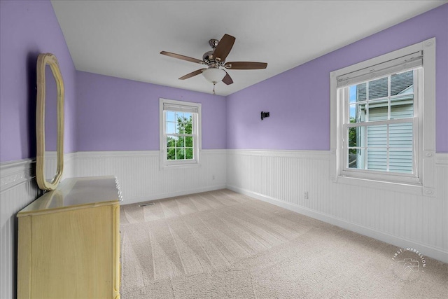 957 Whittington Dr, Geneva, IL 60134 - carpeted empty room with a wainscoted wall and a ceiling fan