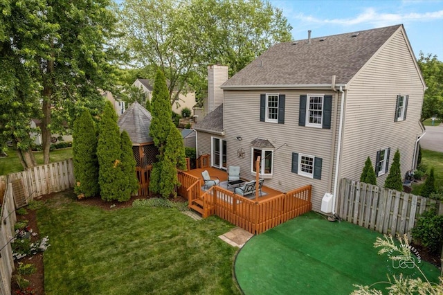 957 Whittington Dr, Geneva, IL 60134 - rear view of house with roof with shingles, a fenced backyard, a wooden deck, and a chimney