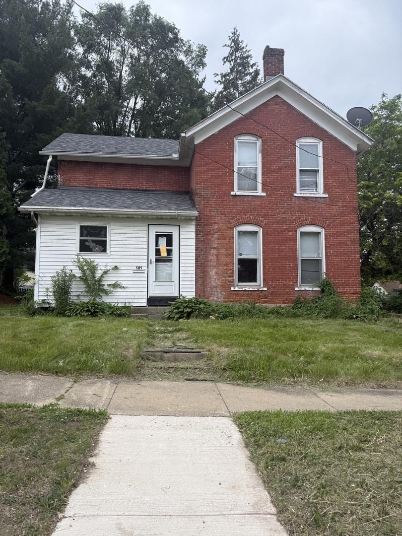 509 W Chestnut St, Freeport, IL 61032 - traditional-style house with a chimney, a shingled roof, and brick siding