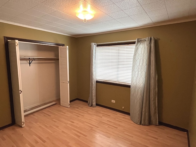 1919 Main Street Rd, Spring Grove, IL 60081 - unfurnished bedroom featuring light wood finished floors, ornamental molding, and a closet