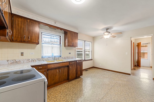 2728 N Neva Ave, Chicago, IL 60707 - kitchen with light countertops, decorative backsplash, light flooring, and a ceiling fan