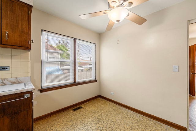 2728 N Neva Ave, Chicago, IL 60707 - unfurnished dining area with ceiling fan and baseboards