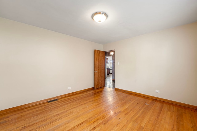 2728 N Neva Ave, Chicago, IL 60707 - spare room featuring baseboards and light wood-type flooring