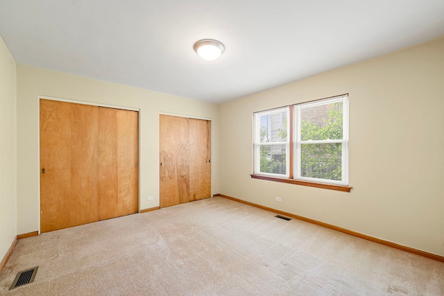 2728 N Neva Ave, Chicago, IL 60707 - unfurnished bedroom featuring two closets and carpet floors