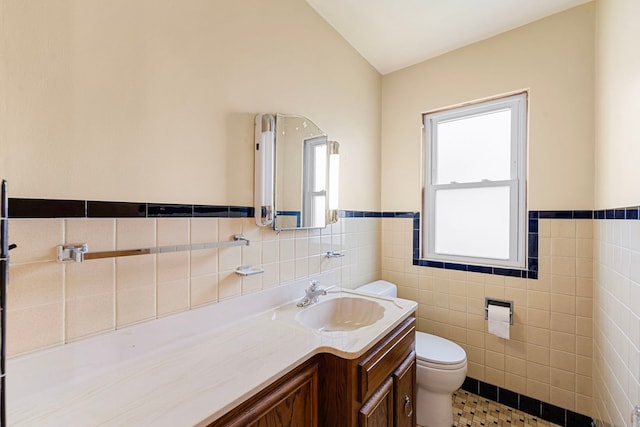 2728 N Neva Ave, Chicago, IL 60707 - bathroom featuring tile walls, vanity, wainscoting, and tile patterned flooring