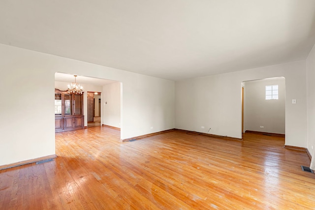 2728 N Neva Ave, Chicago, IL 60707 - unfurnished room with a chandelier and light wood-style flooring