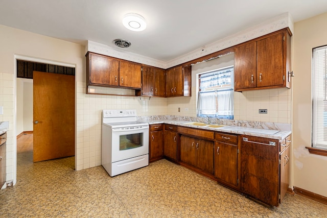 2728 N Neva Ave, Chicago, IL 60707 - kitchen featuring white range with electric stovetop, light countertops, light floors, and backsplash