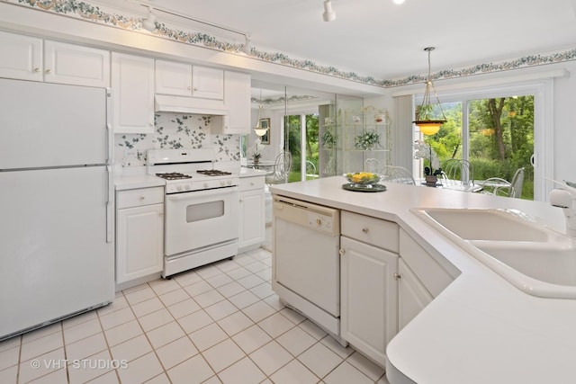 377 Locksley Dr, Streamwood, IL 60107 - kitchen with white appliances, under cabinet range hood, light countertops, light tile patterned flooring, and white cabinetry