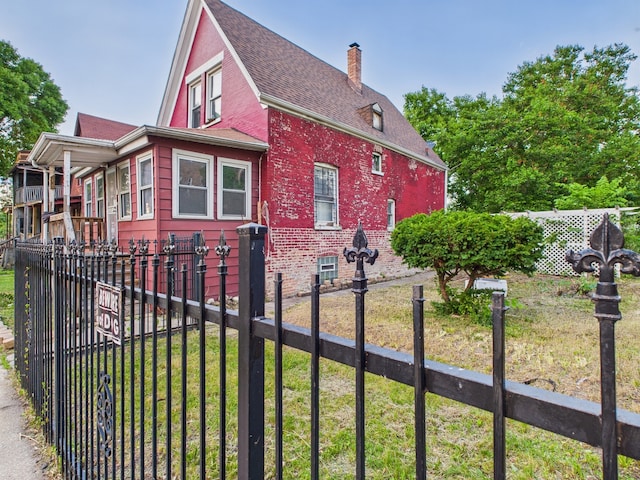 1233 S Karlov Ave, Chicago, IL 60623 - view of side of property featuring a chimney, brick siding, and a shingled roof