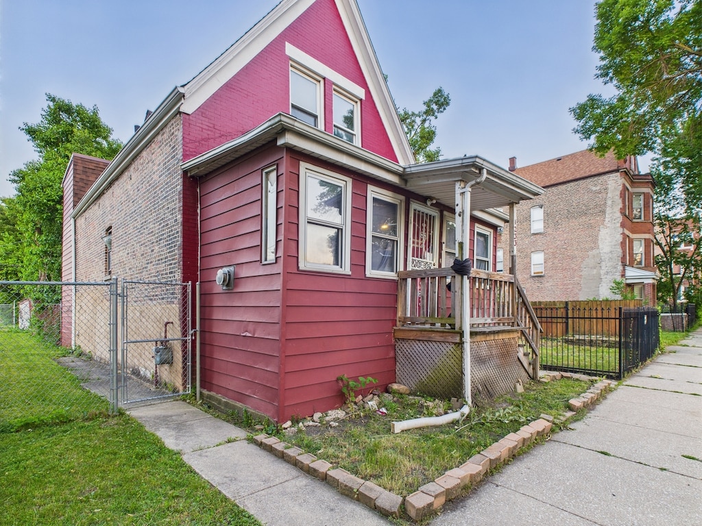 1233 S Karlov Ave, Chicago, IL 60623 - view of front of house featuring a gate and brick siding