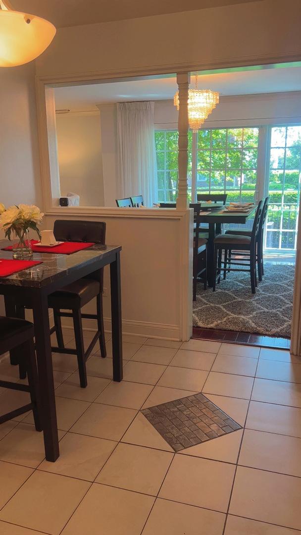 3427 Vollmer Rd Unit 108, Flossmoor, IL 60422 - dining room with light tile patterned floors and a chandelier