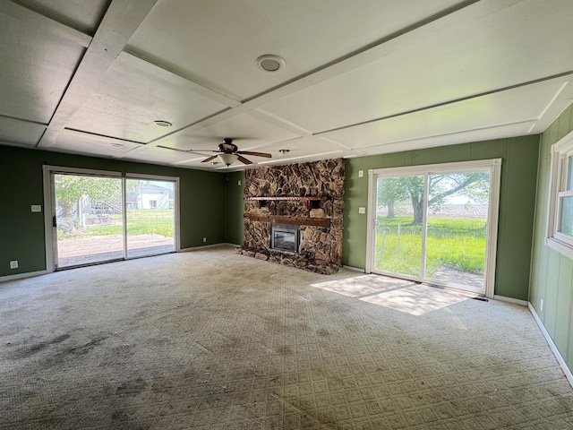 310 N 3rd Ave, Chenoa, IL 61726 - unfurnished living room featuring carpet flooring, a fireplace, a ceiling fan, and baseboards