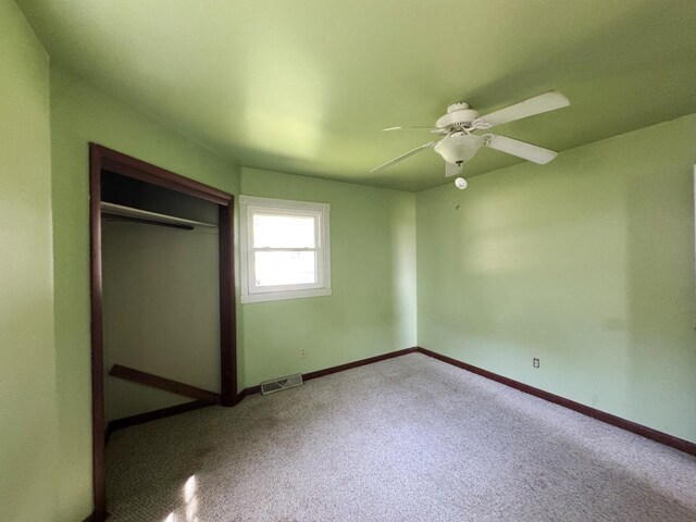 310 N 3rd Ave, Chenoa, IL 61726 - unfurnished bedroom with a closet, baseboards, and a ceiling fan