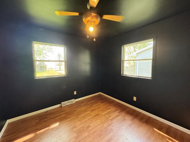 310 N 3rd Ave, Chenoa, IL 61726 - unfurnished room featuring ceiling fan, wood finished floors, and baseboards