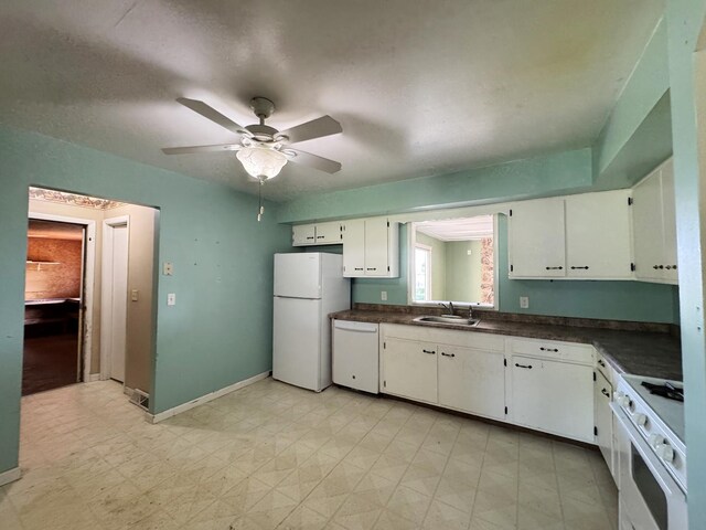 310 N 3rd Ave, Chenoa, IL 61726 - kitchen with white appliances, a sink, dark countertops, white cabinets, and a ceiling fan