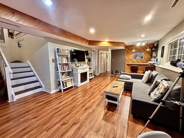 826 Dartmoor Dr, Crystal Lake, IL 60014 - living room with wood finished floors, wooden walls, recessed lighting, stairs, and a fireplace