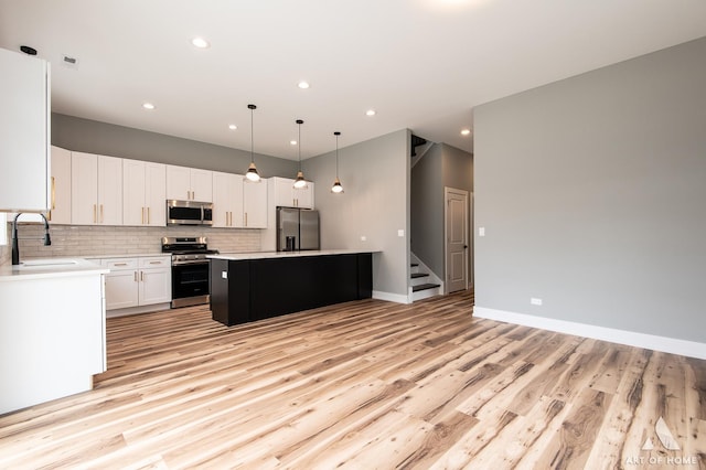 10921 S Hermosa Ave, Chicago, IL 60643 - kitchen featuring stainless steel appliances, a sink, light wood-style flooring, recessed lighting, and light countertops