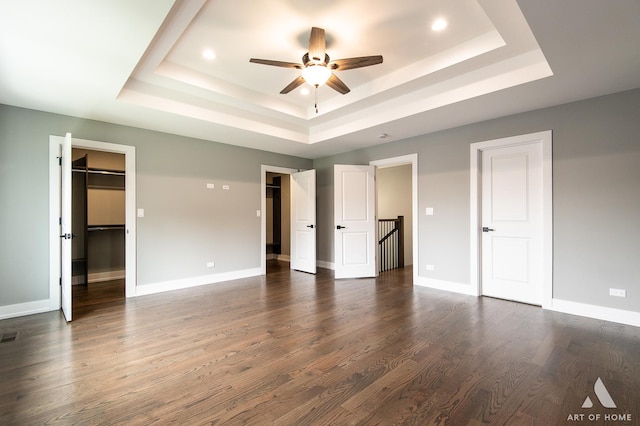 10921 S Hermosa Ave, Chicago, IL 60643 - unfurnished bedroom with a raised ceiling, dark wood finished floors, baseboards, recessed lighting, and a walk in closet