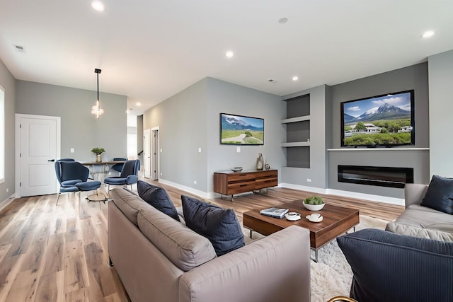 10921 S Hermosa Ave, Chicago, IL 60643 - living room with light wood-type flooring, built in features, baseboards, a glass covered fireplace, and recessed lighting