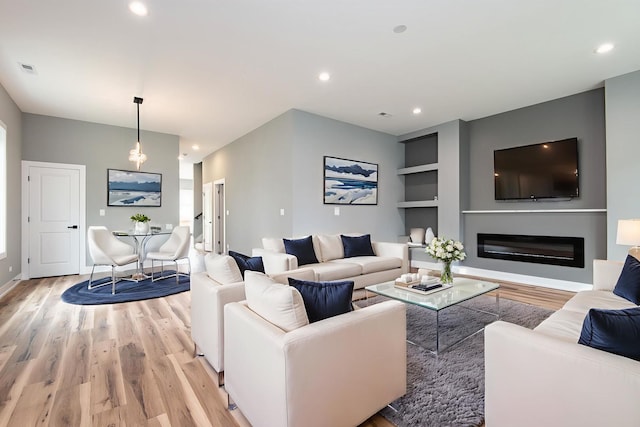 10921 S Hermosa Ave, Chicago, IL 60643 - living room featuring light wood-style flooring, built in features, a glass covered fireplace, recessed lighting, and baseboards