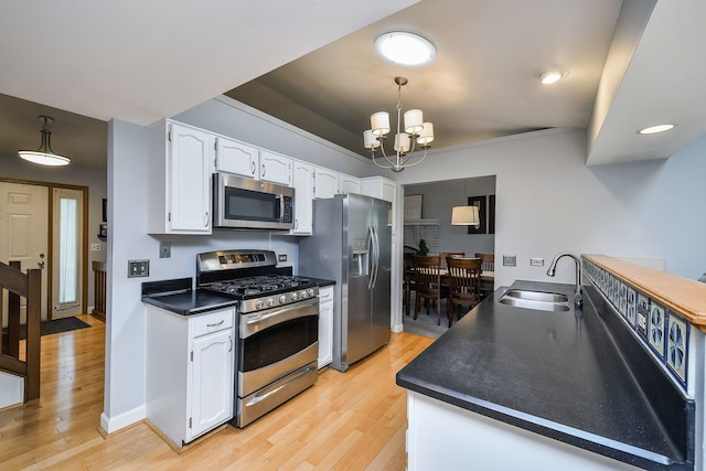 27W108 Walnut Dr, Winfield, IL 60190 - kitchen with stainless steel appliances, white cabinetry, light wood-style flooring, dark countertops, and recessed lighting