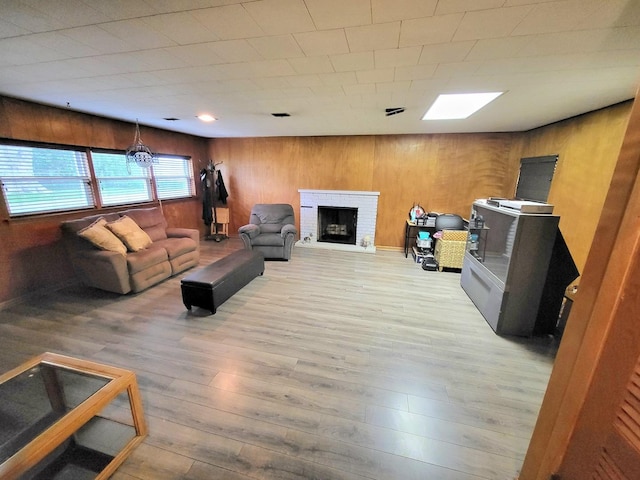 718 Central Park Ave, Flossmoor, IL 60422 - living room with wood finished floors, a brick fireplace, and wooden walls