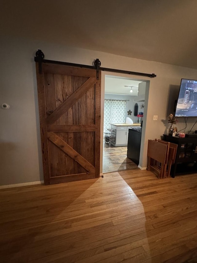 5280 S Harlan Dr, Rochelle, IL 61068 - corridor with wood finished floors, baseboards, and a barn door