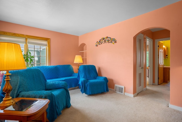 7416 Van Buren Ave, Hammond, IN 46324 - living area featuring arched walkways, carpet flooring, and baseboards