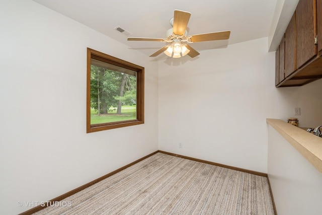 3525 Saint Anthony Way Unit 7A, Rockford, IL 61101 - unfurnished room featuring light colored carpet and a ceiling fan