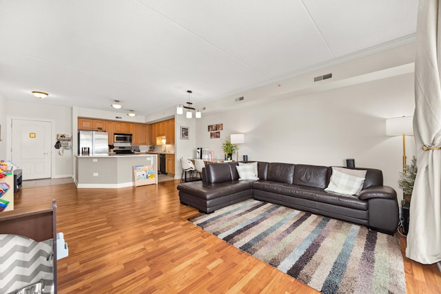 8340 Callie Ave Unit 506, Morton Grove, IL 60053 - living room featuring light wood finished floors, baseboards, and ornamental molding