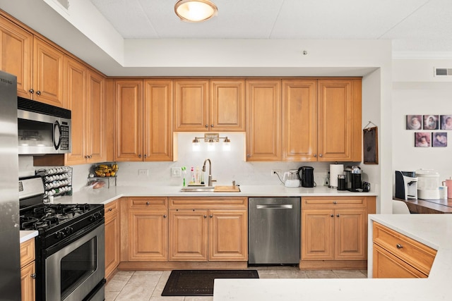 8340 Callie Ave Unit 506, Morton Grove, IL 60053 - kitchen with stainless steel appliances, a sink, light countertops, and light tile patterned flooring