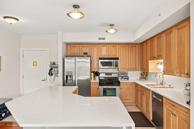 8340 Callie Ave Unit 506, Morton Grove, IL 60053 - kitchen with appliances with stainless steel finishes, a sink, light countertops, and a kitchen island