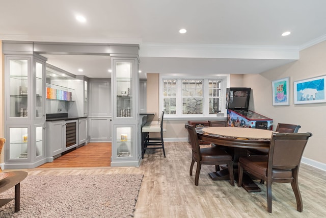 622 S Washington St, Hinsdale, IL 60521 - dining room featuring beverage cooler, crown molding, light wood-style floors, bar, and recessed lighting