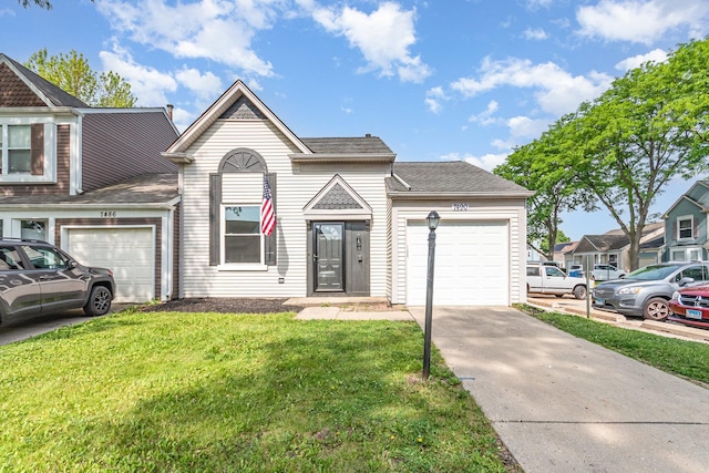 7490 Filmore Ave, Hanover Park, IL 60133 - view of front of home with an attached garage, driveway, a front yard, and roof with shingles