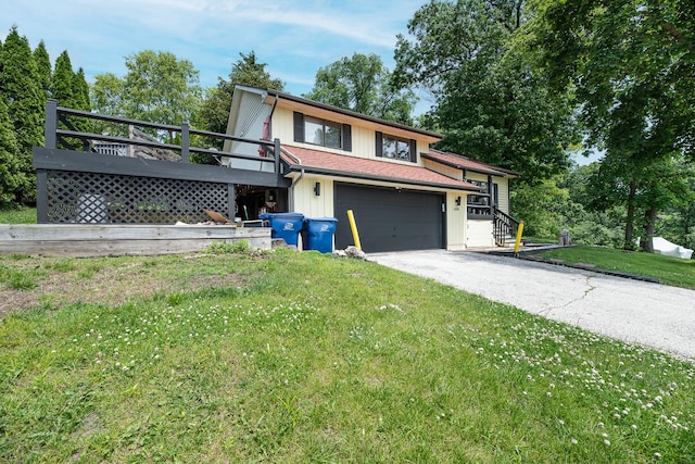 25429 W Cedar Crest Ln, Lake Villa, IL 60046 - view of front of property featuring asphalt driveway, a front lawn, a deck, and a garage