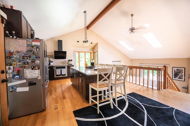 25429 W Cedar Crest Ln, Lake Villa, IL 60046 - kitchen with appliances with stainless steel finishes, light wood-style floors, a skylight, a kitchen breakfast bar, and a center island