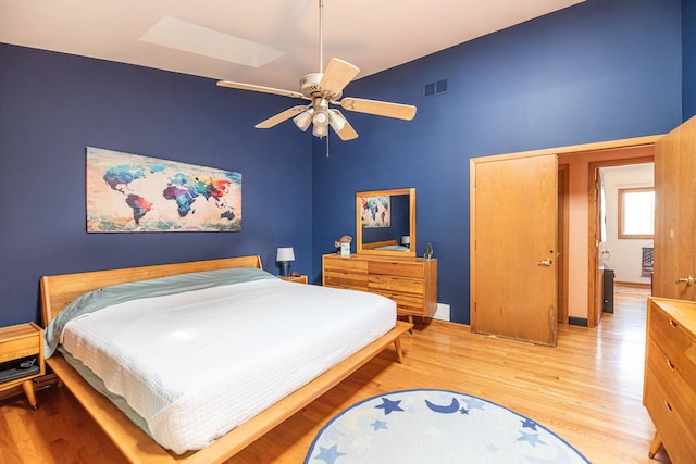 25429 W Cedar Crest Ln, Lake Villa, IL 60046 - bedroom featuring light wood-style flooring, a towering ceiling, a ceiling fan, and a skylight