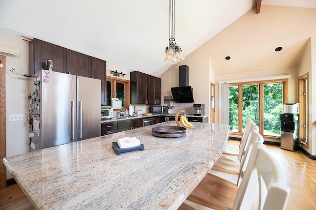 25429 W Cedar Crest Ln, Lake Villa, IL 60046 - kitchen with appliances with stainless steel finishes, dark brown cabinets, light wood-style flooring, light stone countertops, and a large island