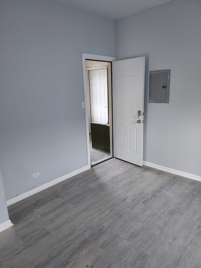 8205 S Houston Ave, Chicago, IL 60617 - unfurnished room featuring electric panel and wood finished floors