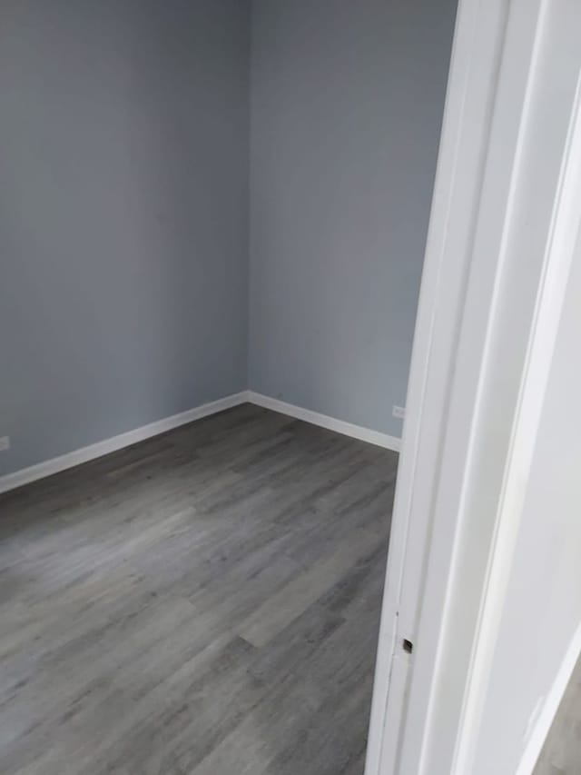 8205 S Houston Ave, Chicago, IL 60617 - spare room with dark wood finished floors and baseboards