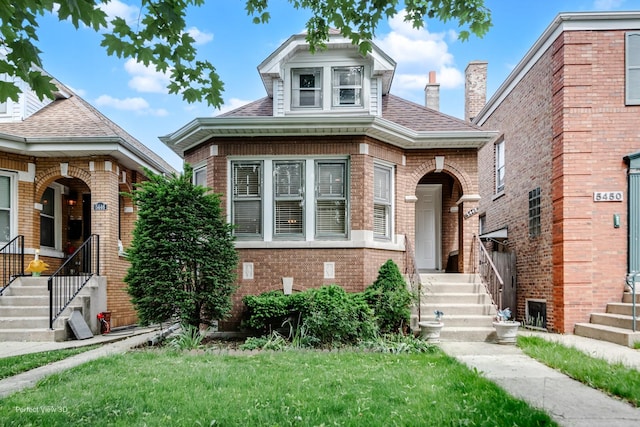 5448 N Lieb Ave, Chicago, IL 60630 - view of front of home with brick siding, a front yard, and a shingled roof