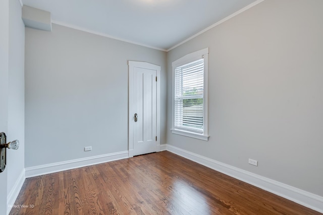 5448 N Lieb Ave, Chicago, IL 60630 - spare room featuring baseboards, dark wood-style flooring, and crown molding
