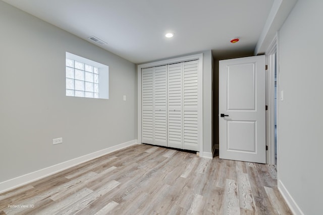 5448 N Lieb Ave, Chicago, IL 60630 - unfurnished bedroom featuring light wood finished floors, a closet, baseboards, and recessed lighting